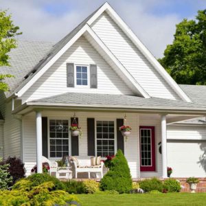 exterior of cute white house with sunny porch